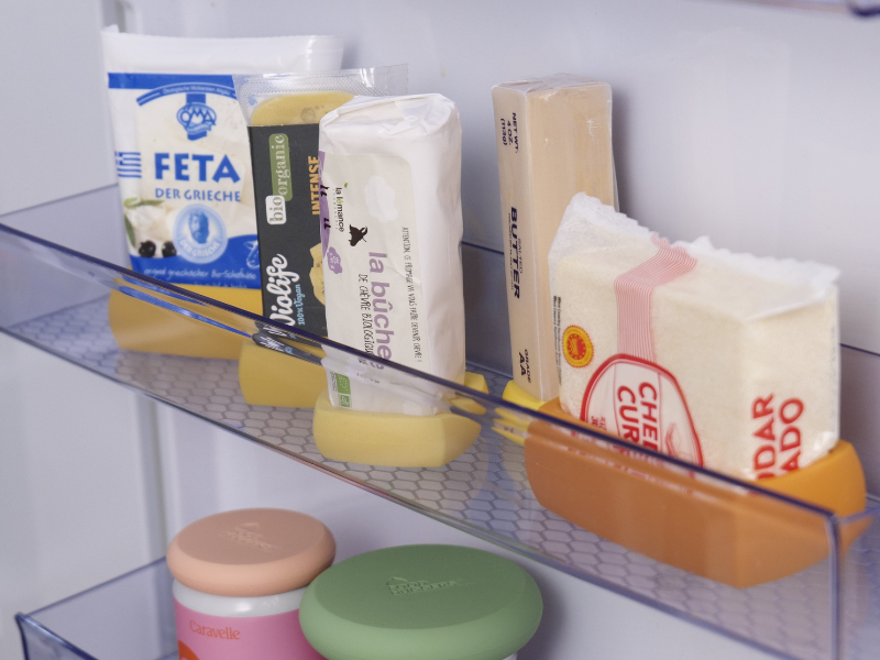 Cheese Huggers and a Butter Hugger organizing the door of the fridge and keeping cheese fresh
