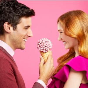 An image of a man and a woman sharing an ice cream cone filled with Jelly Belly Jelly Beans